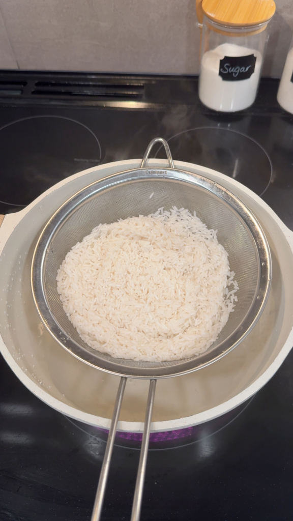 Sticky Rice in Mesh Sieve Over a Pot of Water