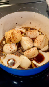 Onions and stock in pot