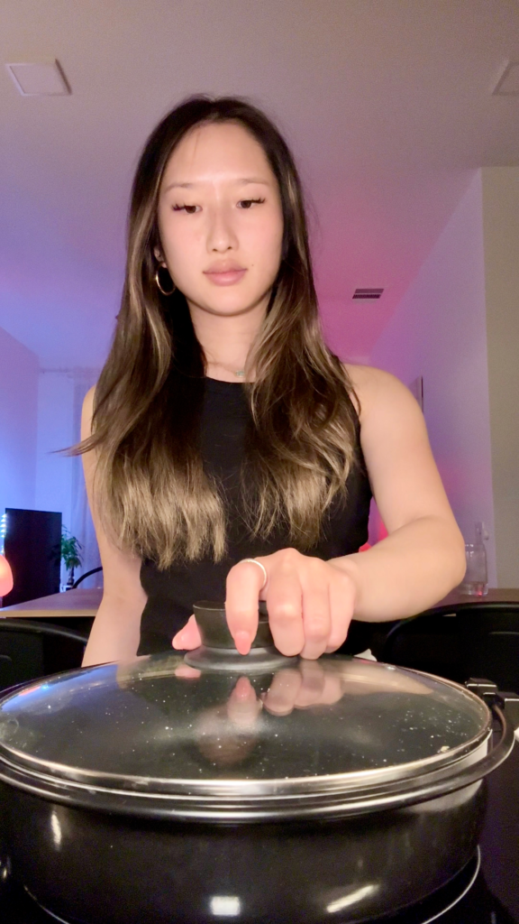 Girl holding nabe hot pot bowl on stove