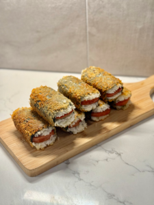 Musubi Close-up shot of crispy spam musubi showing golden seared Spam and glossy nori wrap