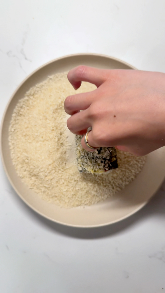 close-up shot of spam musubi being coated in panko bread crumbs