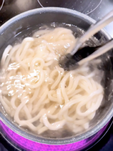 Udon noodles being boiled